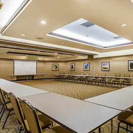 U-shaped table with chairs in meeting room